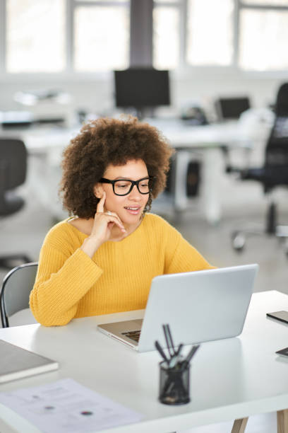istock Smiling businesswoman using laptop in modern office. 1143744788
