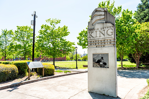 Atlanta, USA - April 20, 2018: Sign to Martin Luther King Jr National historic site in Georgia city in summer with park view