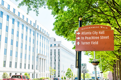 Atlanta, USA - April 20, 2018: Road direction sign for government walk, peachtree street, city hall and Turner field baseball stadium in Georgia city in summer on street
