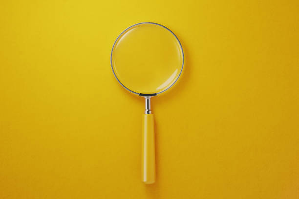 istock Yellow Magnifier On Yellow Background 1143748730