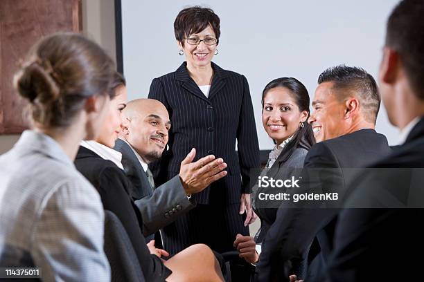 Diverse Businesspeople Conversing Woman At Front Stock Photo - Download Image Now - Business, Instructor, Latin American and Hispanic Ethnicity