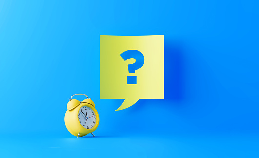 Yellow alarm clock with a yellow speech bubble and question mark on blue background. Start writes on the speech bubble. Horizontal composition with copy space.
