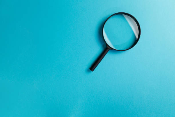 istock Magnifying glass on blue background. Top view. Flat lay. Copy space. Minimal creative concept. Search concept 1143752823