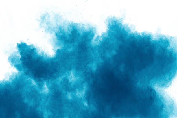 istock Blue color powder explosion cloud on white background.Closeup of Blue dust particles splash on background. 1143755948