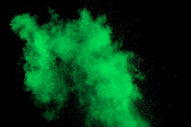istock Green color powder explosion cloud  on black background.Green dust splash on dark background. 1143755962