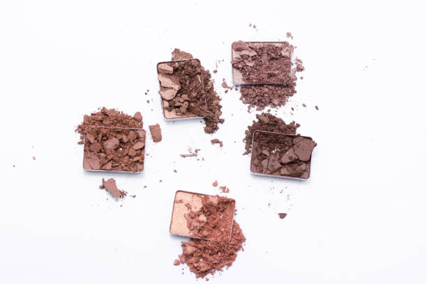 istock Deep brown crumbled eye shadow isolated on white background. 1143756107