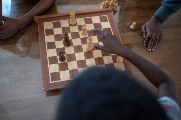 istock Kids playing chess shot from directly above 1143759113