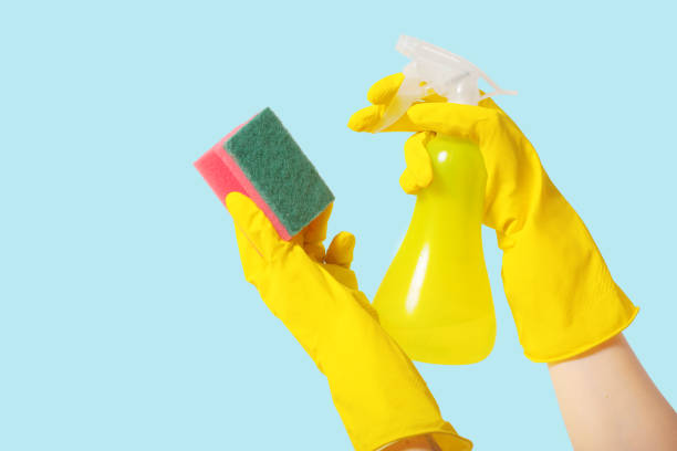 istock cleaner Hand in protective gloves wash the surface, isolated on color background 1143761924