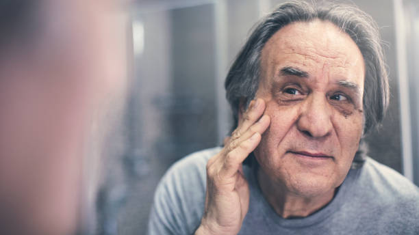 istock Mature man checking his wrinkles 1143763161