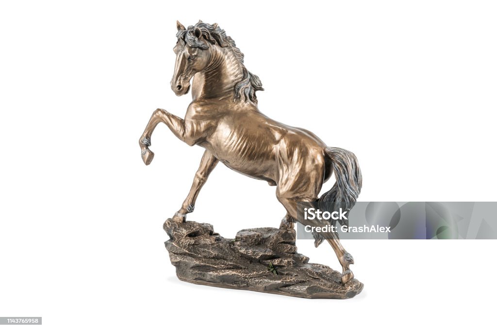 bronze horse statuette on white beautiful bronze statuette of a horse with a raised hoof, isolated on white background Horse Stock Photo