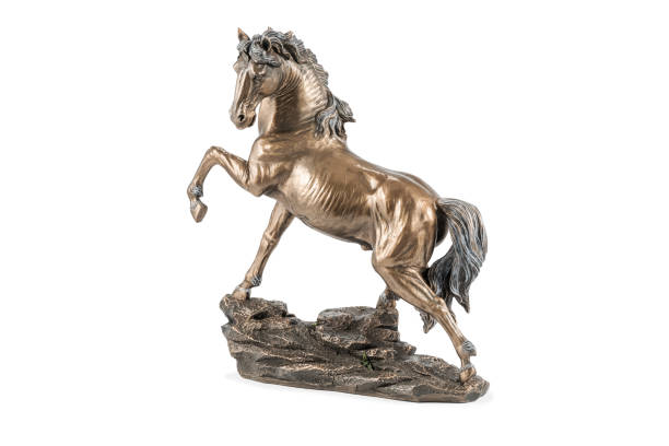 bronze horse statuette on white beautiful bronze statuette of a horse with a raised hoof, isolated on white background figurine stock pictures, royalty-free photos & images
