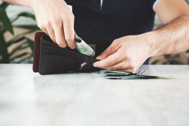 istock man hand money with wallet 1143767569