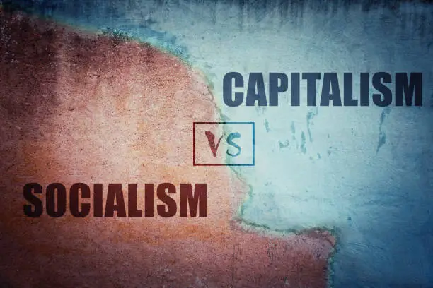 Photo of Socialism versus capitalism split concrete wall