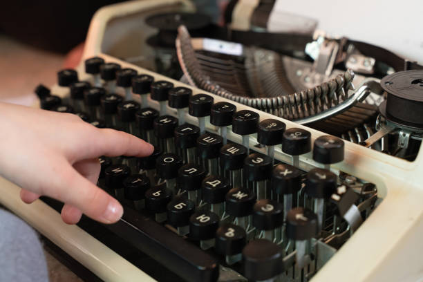 istock Hands writing on an old typewriter. retro-style. keyboard and font 1143773054