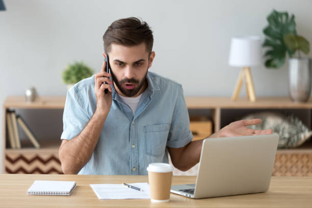 istock Outraged unhappy businessman talking on phone, unpleasant conversation 1143775421
