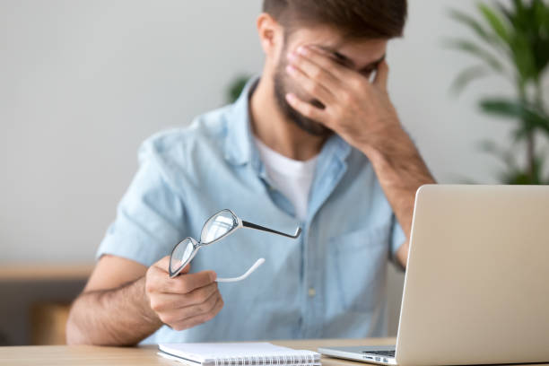 istock Man suffering from dry eyes syndrome after long computer work 1143775448
