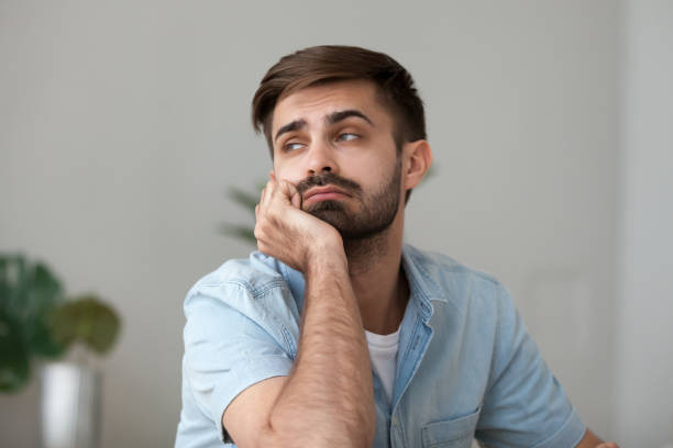 istock Tired bored man looking in distance, feeling lazy, lack motivation 1143775456