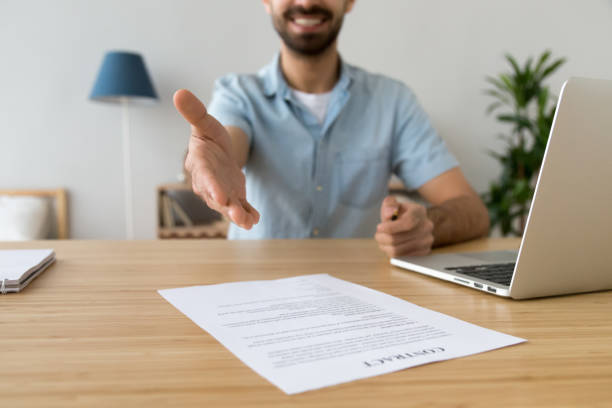 istock Businessman extending hand for handshake, offer to sign contract 1143775467