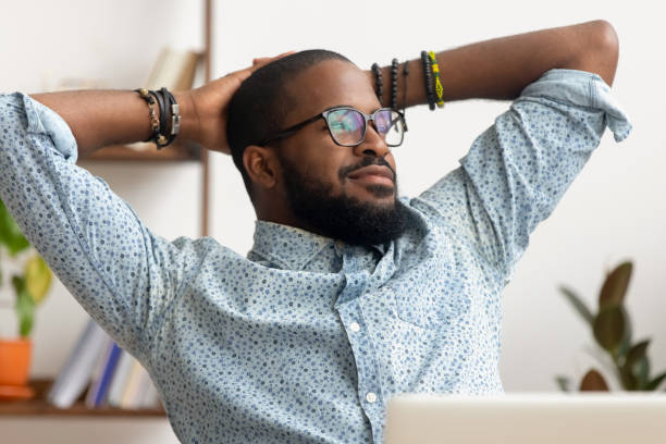 istock Dreamy African American businessman relaxing after finished work 1143790718
