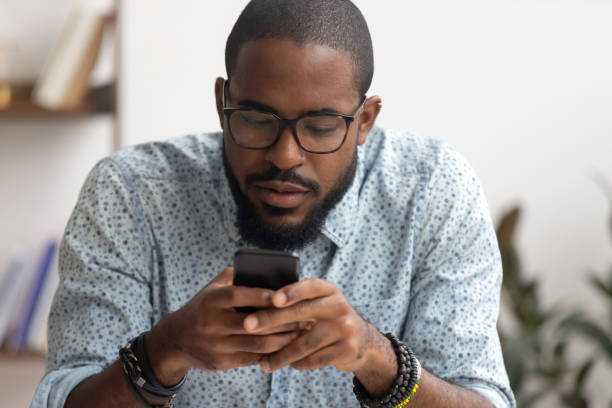 istock African American businessman using smartphone, looking at screen 1143790726