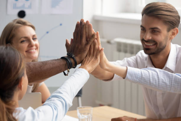 istock Close up diverse colleagues giving high five, celebrate great results 1143790806