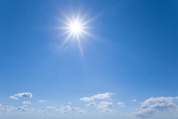 istock blue sky with clouds and sparkle sun, natural background 1143792283