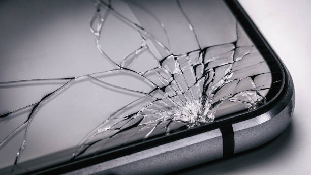 Broken mobile phone screen close up. Weak glass in modern gadgets stock photo