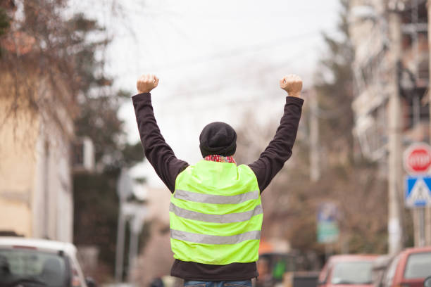 istock yellow vest political activist protesting on street 1143796436