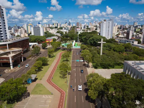 Aerial image of the city of Cascavel - Paraná held on a sunny day and with some clouds of the sky. In the image we have Avenida Brasil and Praça do Migrante.