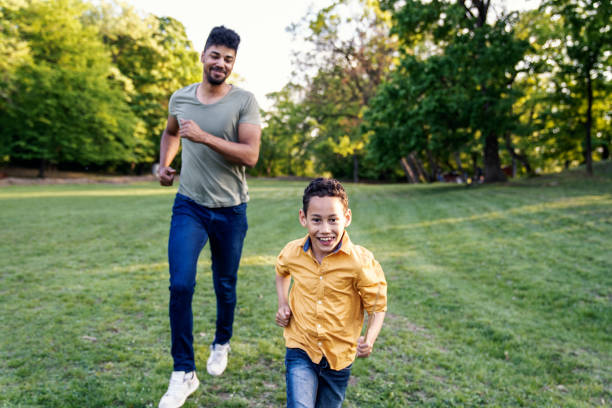 istock Father and son running and chasing each other in park 1143801362