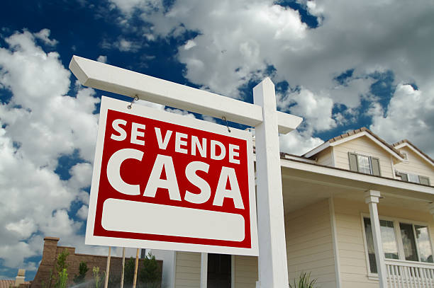 Se Vende Casa Spanish Real Estate Sign and House Se Vende Casa Spanish Real Estate Sign and House and Blue Sky with Clouds. casa stock pictures, royalty-free photos & images
