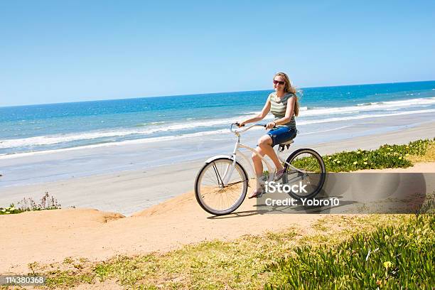 Woman On A Bicycle Ride Along The Beach Stock Photo - Download Image Now - Beach, San Diego, Bicycle