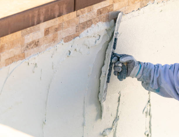 istock Worker Smoothing Wet Pool Plaster With Trowel 1143807090