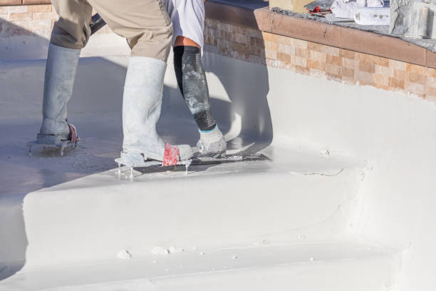istock Worker Wearing Spiked Shoes Smoothing Wet Pool Plaster With Trowel 1143807096
