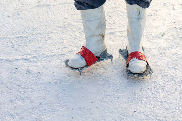 istock Worker Wearing Spiked Shoes Standing in Wet Plaster During Pool Build 1143807190