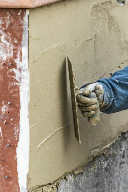 istock Tile Worker Applying Cement with Trowel at Pool Construction Site 1143808279
