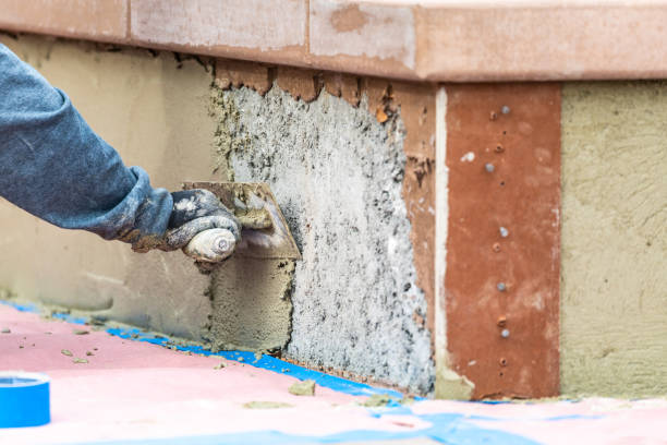 istock Tile Worker Applying Cement with Trowel at Pool Construction Site 1143808553