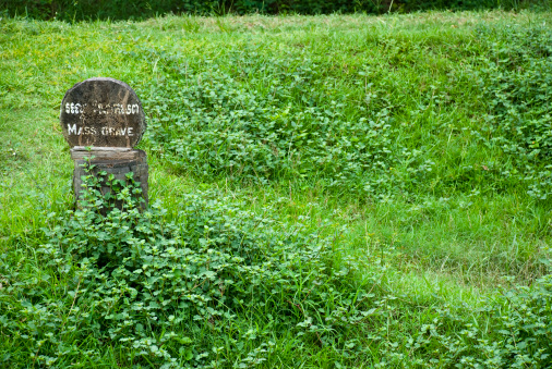 A sign marks a mass grave location at Choeung Ek, the infamous Killing Fields south of Phnom Penh, Cambodia