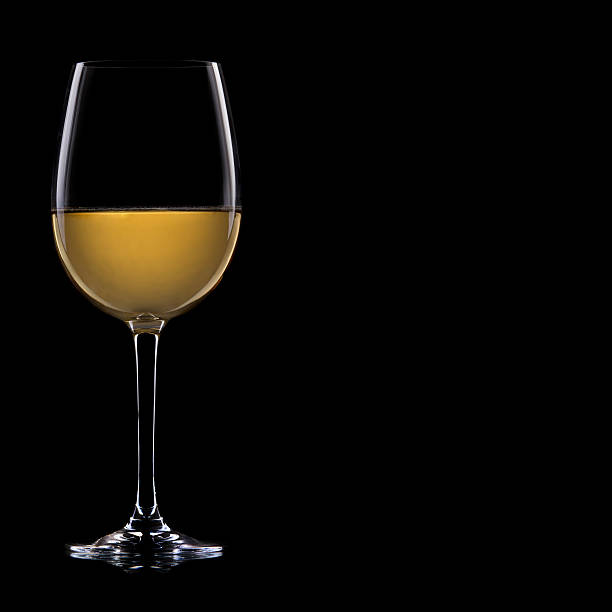 istock Glass of white wine, isolated on a black background. 114381955