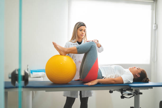 Occupational therapy with women Occupational Therapy, Patient, Pediatrician, People, Physical Injury physical therapy stretching stock pictures, royalty-free photos & images