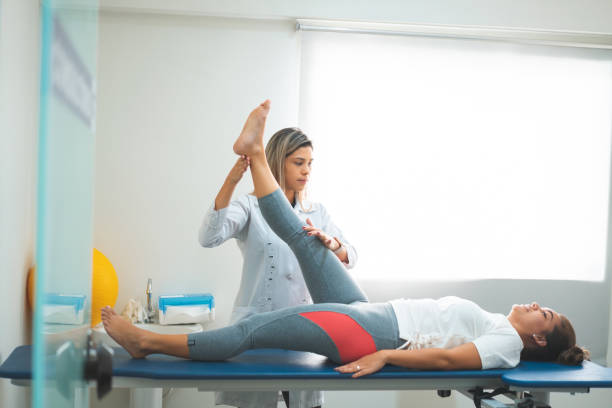 Doctor bending her patient's leg