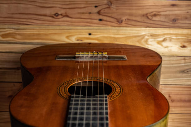 istock Old classical guitar on wooden background 1143822815