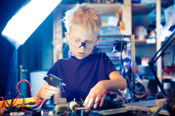 istock Boy and hot glue gun 1143824234