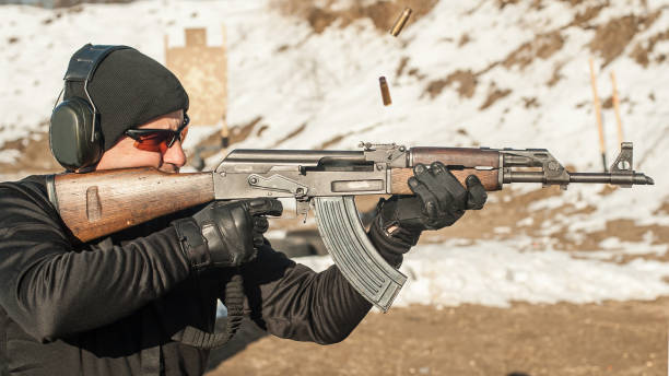istock Civilian shooting training from rifle machine gun on shooting range 1143824392