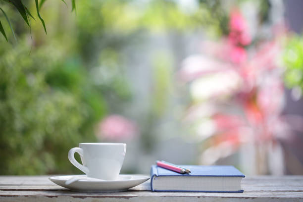 istock White coffee cup with plant and notebooks 1143825020