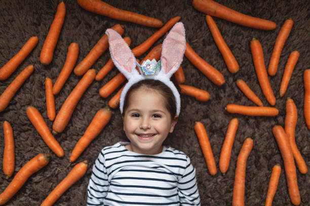 istock Cute smiling child with rabbit ears and a crown during Easter 1143827510