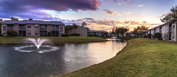istock Bench overlooking a large pond with a fountain 1143830601