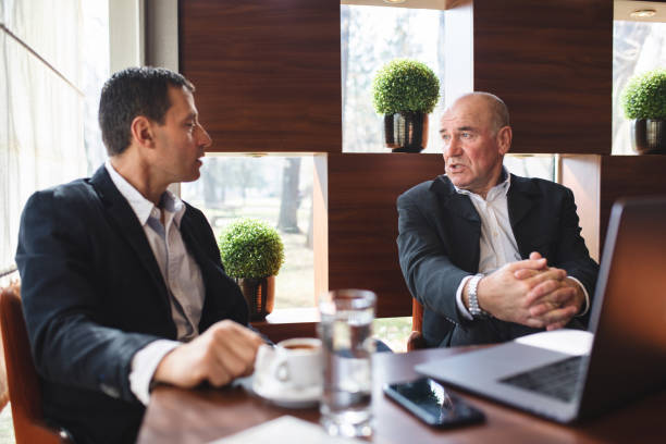 istock Senior men having a business discussion at a cafe 1143833167