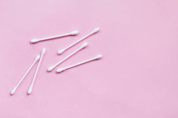 istock Pattern of cotton buds on a pink background 1143836058