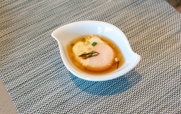 istock Onsen egg in Japanese style bowl on silver woven table mat. 1143838650